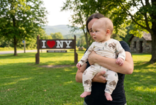 Load image into Gallery viewer, Baby boy in the bison romper near an I Love New York sign