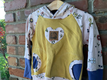 Load image into Gallery viewer, Floral heart applique with a stitched patch reading Kind Words Are Like Honey on yellow fabric.
