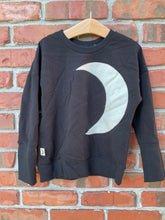 Load image into Gallery viewer, Black ribbed cuff and waistband with small moon-themed side label.
