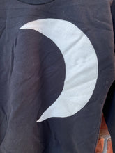 Load image into Gallery viewer, Black long sleeve shirt with a large pale crescent moon appliqué and extended ribbed cuffs.
