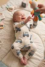 Load image into Gallery viewer, Baby enjoying playful toy time in the tractor romper
