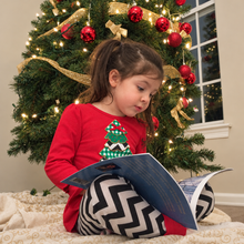 Load image into Gallery viewer, Lightly enhanced photo of a child reading Critter Tails
