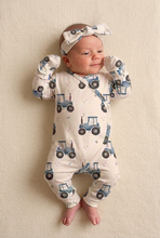Load image into Gallery viewer, Same baby girl and tractor outfit lying on a cream blanket
